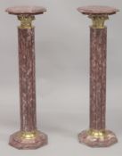 A PAIR OF RED MARBLE COLUMNS. 3ft 4ins high.
