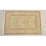 A GOOD SMALL PERSIAN SILK RUG, CREAM GROUND with stylised floral decoration, within a similar