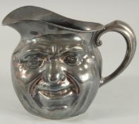 A SILVER PLATED TOBY JUG. 6.5ins high.