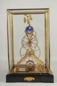 A GILT EAGLE MOONPHASE SKELETON CLOCK in a glass case. 17ins high.