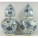 A GOOD PAIR OF CHINESE BLUE AND WHITE PORCELAIN GOURD VASES. 24ins high.