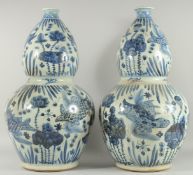 A GOOD PAIR OF CHINESE BLUE AND WHITE PORCELAIN GOURD VASES. 24ins high.