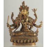 A GILT BRONZE MULTI ARMED DEITY set with beads. 8.5ins high.