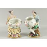 A PAIR OF SEVRES DESIGN PORCELAIN FIGURES OF A MAN AND WOMAN HOLDING BOWLS, the bases with