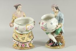 A PAIR OF SEVRES DESIGN PORCELAIN FIGURES OF A MAN AND WOMAN HOLDING BOWLS, the bases with