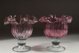 A PAIR OF CRANBERRY CIRCULAR BOWLS. 7.5ins high.