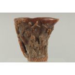 A SMALL CARVED LIBATION CUP carved with birch and foliage. 4.5ins high, 4.75ins wide overall.