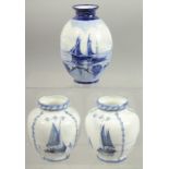 A ROYAL CROWN DERBY SET OF THREE VASES painted with sailing vessels by W.E.J. DEAN.