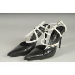 A PAIR OF CHANEL BLACK AND WHITE HIGH HEEL SHOES, heel 4.5ins high, with diamante buckles. Size 39.5