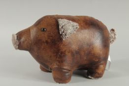 A LEATHER PIG DOOR STOP. 14ins long.