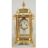 A GOOD GILT BRONZE FOUR GLASS CLOCK with pineapple finials on claw feet. 24ins high.