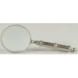 A MAGNIFYING GLASS with chrome handle.