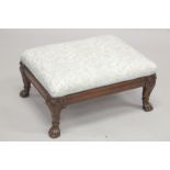 A GEORGIAN MAHOGANY RECTANGULAR PADDED TOP FOOT STOOL supported on claw and ball feet. 1ft 11ins