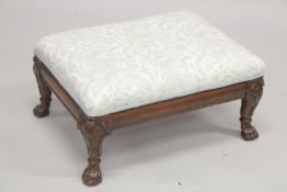 A GEORGIAN MAHOGANY RECTANGULAR PADDED TOP FOOT STOOL supported on claw and ball feet. 1ft 11ins