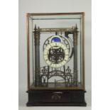 A LARGE MOONFACE CONGREAVE CLOCK in a glass case.