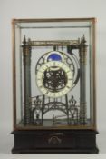A LARGE MOONFACE CONGREAVE CLOCK in a glass case.
