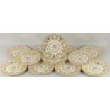 A SET OF TWELVE ROYAL IVORY FLORAL AND GILT PLATES. 11ins diameter.