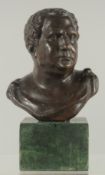 A BRONZE BUST on a marble base. 6ins high.
