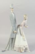 A LARGE LLADRO PORCELAIN GROUP, TWO LONG FIGURES, a dog at their feet. 20ins high.