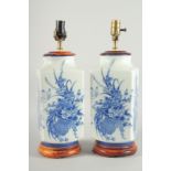 A PAIR OF CHINESE BLUE AND WHITE PORCELAIN SQUARE VASE LAMPS. 19ins high.
