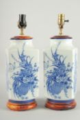 A PAIR OF CHINESE BLUE AND WHITE PORCELAIN SQUARE VASE LAMPS. 19ins high.