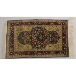 A GOOD SMALL PERSIAN SILK RUG, rich blue central panel with stylised flowers, vases of flowers to