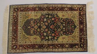 A GOOD SMALL PERSIAN SILK RUG, rich blue central panel with stylised flowers, vases of flowers to