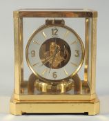 A LE COULTRE ATMOS CLOCK. No. 176787, with glass case. 9.5ins high.