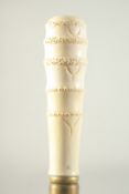A WALKING STICK with carved bone handle, 'FAUX BAMBOO'.