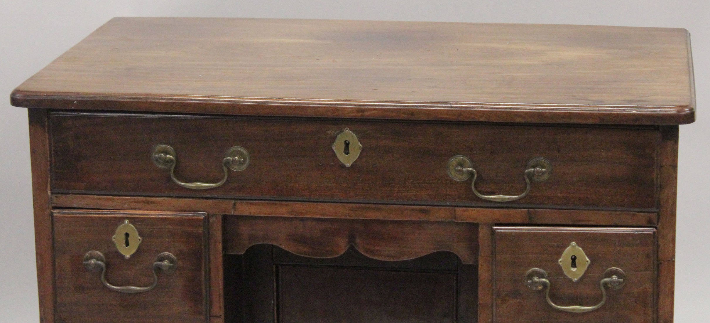 A GOOD GEORGE III MAHOGANY KNEEHOLE DESK with plain top, three small drawers either side of the