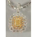 AN 18 CARAT WHITE GOLD, NATURAL YELLOW DIAMOND AND DIAMOND PENDANT and fancy chain.