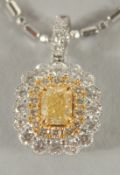 AN 18 CARAT WHITE GOLD, NATURAL YELLOW DIAMOND AND DIAMOND PENDANT and fancy chain.