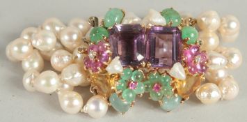 A SUPERB FOUR ROW PEARL BROOCH with large tuti fruiti semi precious stone clasp.