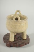 A CHINESE CRACKLE GLAZE TRIPOD CENSER with hardwood stand.