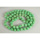 A LARGE STRING OF JADE BEADS. 34ins long.