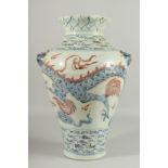 A LARGE CHINESE BLUE AND WHITE VASE with dragon decoration. 17ins high.