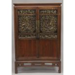 A 19TH CENTURY CHINESE CABINET with carved and pierced doors. 5ft high, 3ft 4ins wide.