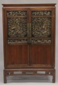 A 19TH CENTURY CHINESE CABINET with carved and pierced doors. 5ft high, 3ft 4ins wide.