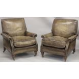 A SUPERB PAIR OF LEATHER ARMCHAIRS with brass studs on turned legs, with brass casters. 2ft 8ins