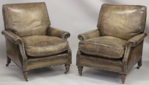 A SUPERB PAIR OF LEATHER ARMCHAIRS with brass studs on turned legs, with brass casters. 2ft 8ins