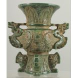 AN ARCHAIC CARVED JADE VASE carved with dragons. 7.25ins high.