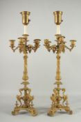 A GOOD PAIR OF BRONZE CANDLESTICKS with four scrolling branches. 28ins high.