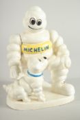 A CAST IRON MITCHELIN MAN and dog. 8ins high