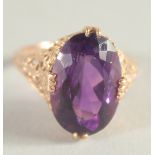 A 14CT GOLD AMETHYST SINGLE STONE RING.