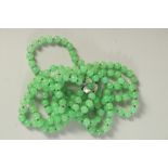 A GOOD DOUBLE ROW OF JADE BEADS with white gold clasp. 13ins long..