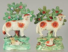 A PAIR OF STAFFORDSHIRE BOCAGE GROUP OF SHEEP with lambs, with bocage backs.