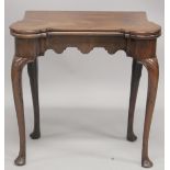 A GOOD GEORGE II MAHOGANY SHAPED FOLDING SWIVEL TOP CARD TABLE with green baize cover and counter
