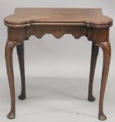 A GOOD GEORGE II MAHOGANY SHAPED FOLDING SWIVEL TOP CARD TABLE with green baize cover and counter