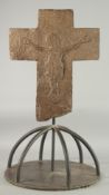 AN EARLY CARVED STONE CROSS with a carved figure of Jesus Christ. 16ins high, 14ins wide.