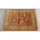 A VERY GOOD PERSIAN SILK HUNTING RUG red ground with figures of huntsmen on horseback, animals and